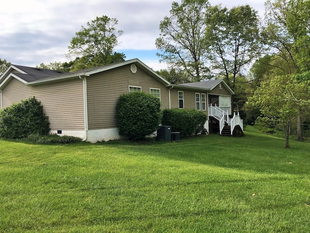 view of front of property with a front yard and central air condition unit