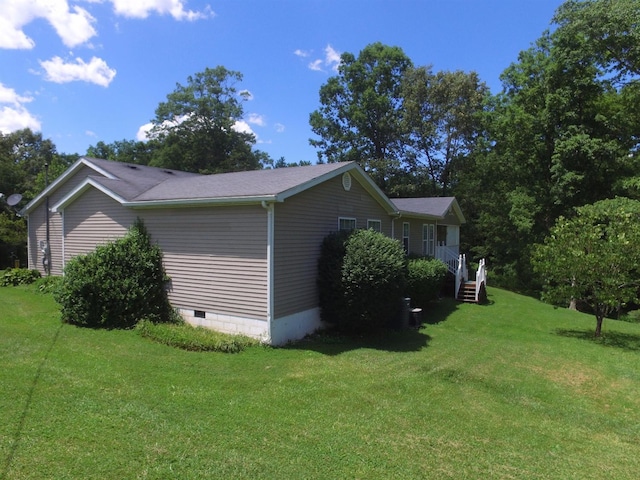 view of side of home featuring a yard