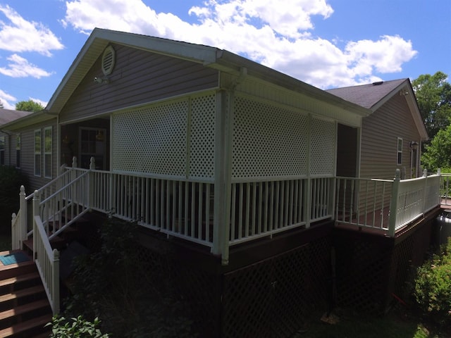 view of side of property with a wooden deck