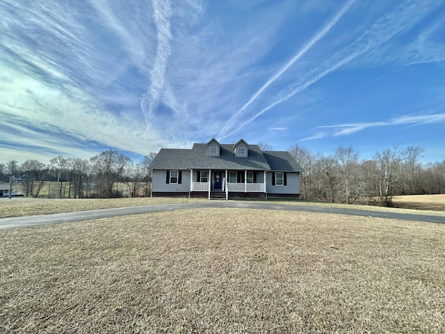 view of front of property with a porch and a front lawn