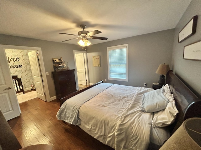 bedroom featuring ceiling fan and dark hardwood / wood-style floors