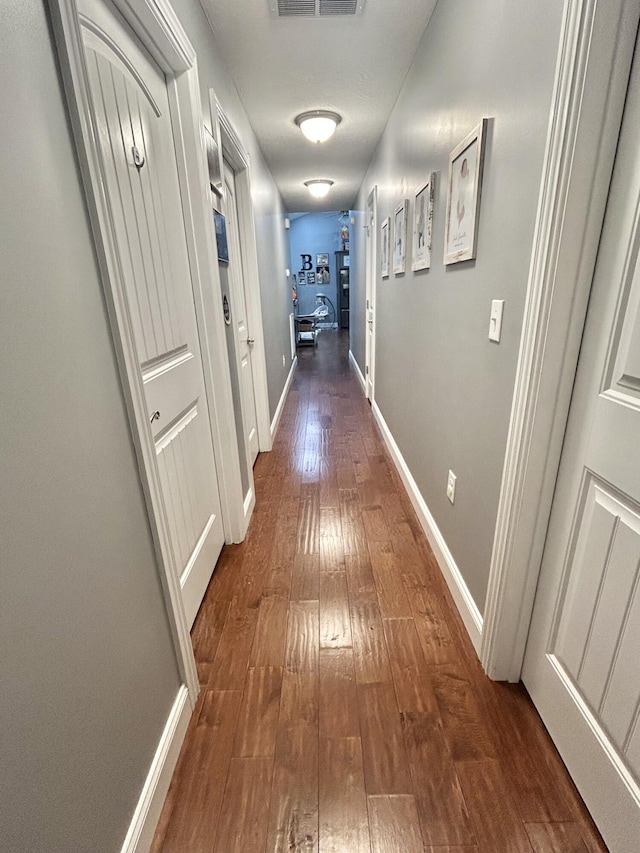 corridor with dark hardwood / wood-style floors