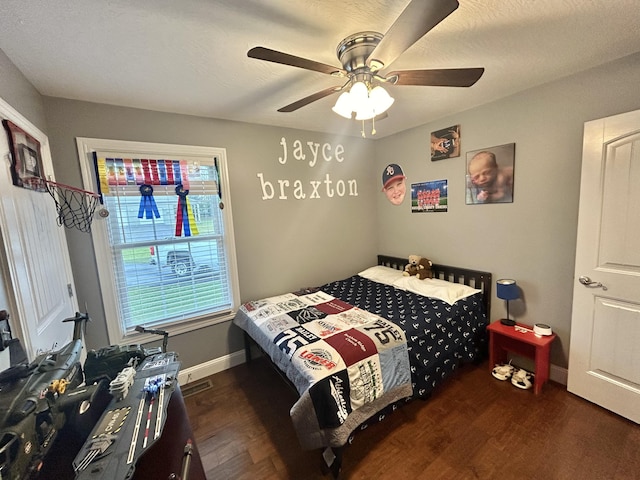 bedroom with dark wood-type flooring and ceiling fan