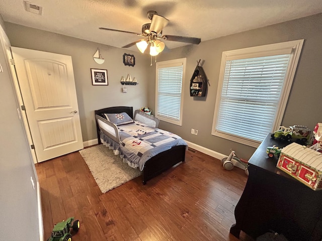 bedroom featuring dark wood-type flooring and ceiling fan