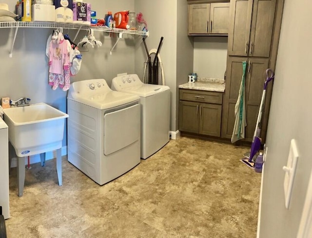 laundry area with cabinets, sink, and washing machine and clothes dryer