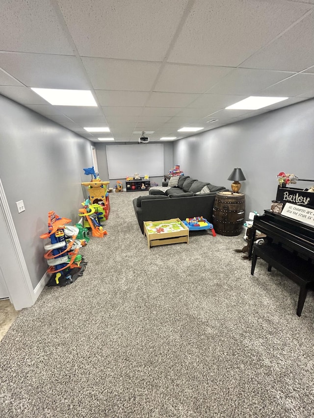 playroom featuring a drop ceiling and carpet floors