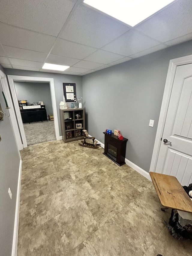 interior space with a paneled ceiling