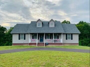 view of front of house with a front yard and covered porch