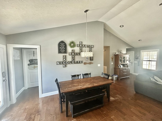 dining room featuring lofted ceiling, dark hardwood / wood-style floors, and a textured ceiling