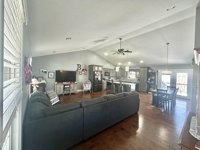 living room featuring lofted ceiling, dark hardwood / wood-style floors, and ceiling fan