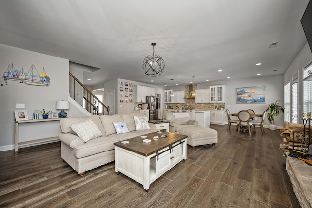 living room featuring dark hardwood / wood-style flooring and a chandelier