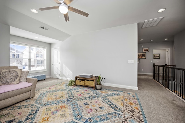 carpeted living room featuring ceiling fan and vaulted ceiling