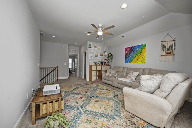 living room featuring ceiling fan, carpet flooring, and vaulted ceiling