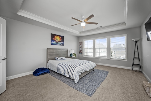 bedroom featuring carpet, ceiling fan, and a tray ceiling