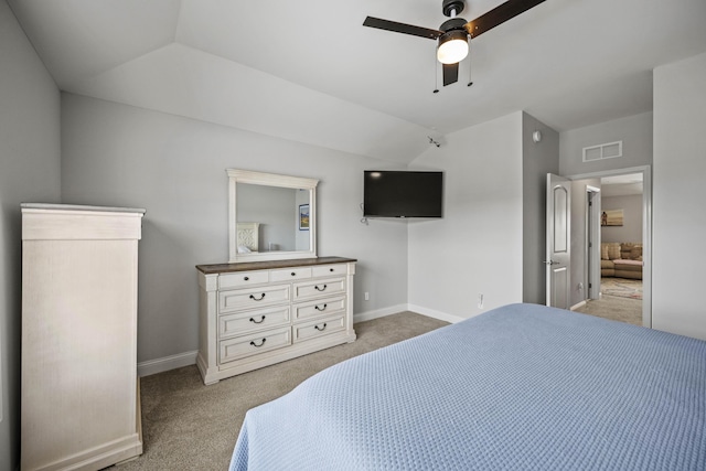 carpeted bedroom with ceiling fan and vaulted ceiling