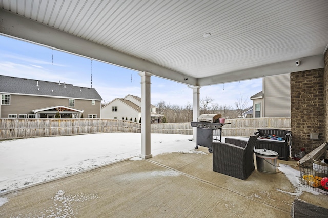 snow covered patio with area for grilling