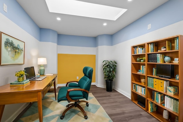 office space featuring dark hardwood / wood-style flooring and a skylight