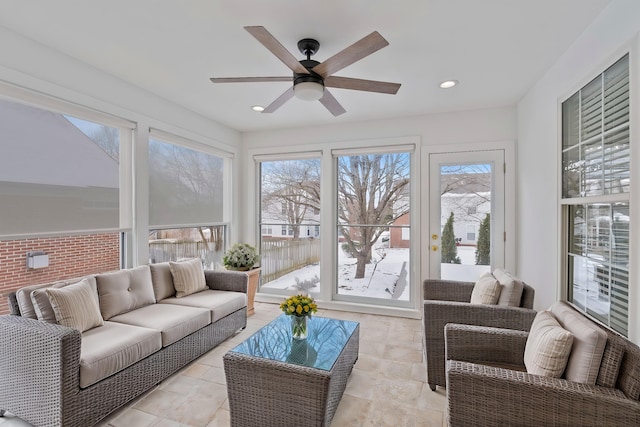 sunroom / solarium featuring ceiling fan and a healthy amount of sunlight