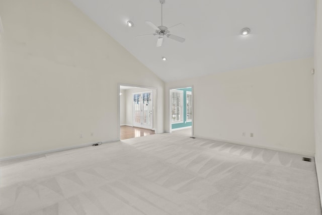 unfurnished living room featuring ceiling fan, high vaulted ceiling, and light carpet