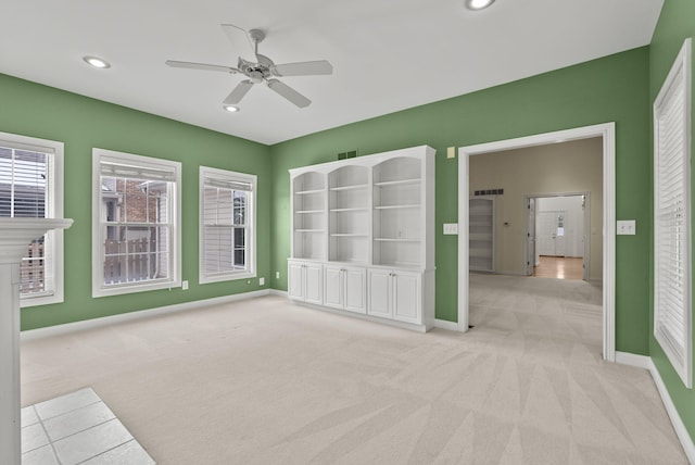 unfurnished room featuring ceiling fan and light colored carpet