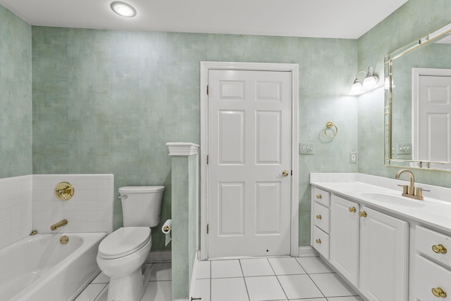 bathroom featuring tile patterned flooring, vanity, a bathing tub, and toilet