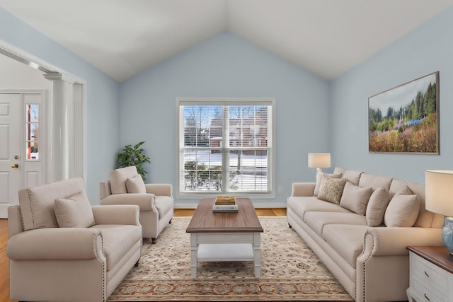 living room with lofted ceiling and light hardwood / wood-style floors