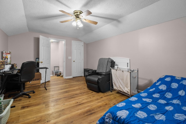 bedroom featuring wood-type flooring, vaulted ceiling, ceiling fan, and a textured ceiling