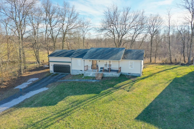 view of front of house featuring a garage, covered porch, and a front lawn