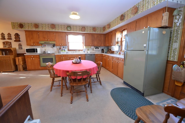 kitchen with sink, range, light carpet, fridge, and dishwasher