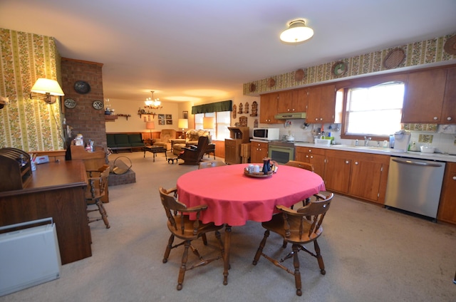 carpeted dining area featuring sink and a notable chandelier