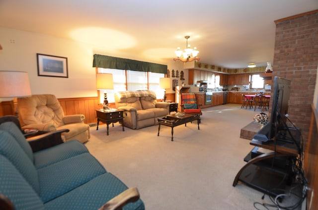 carpeted living room featuring a chandelier