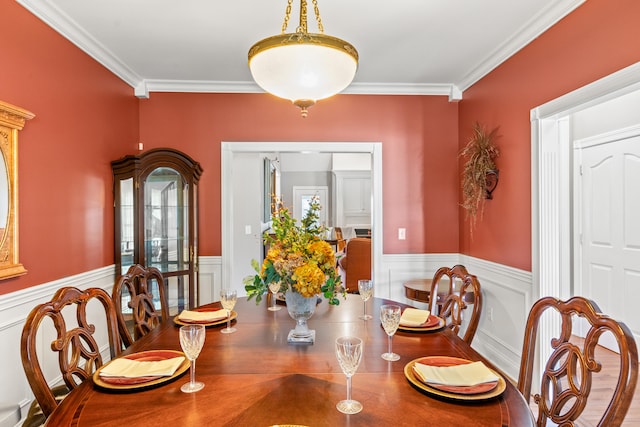 dining space featuring crown molding