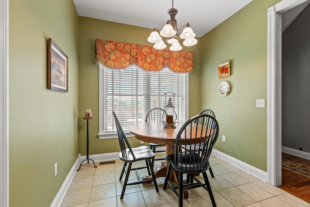 tiled dining area featuring an inviting chandelier