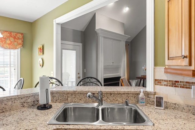 2040 Indigo Dr, Richmond, KY 40475 - kitchen with a sink, light stone counters, and tasteful backsplash