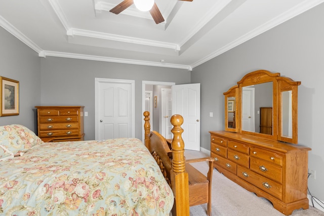 carpeted bedroom featuring crown molding, ceiling fan, and a tray ceiling