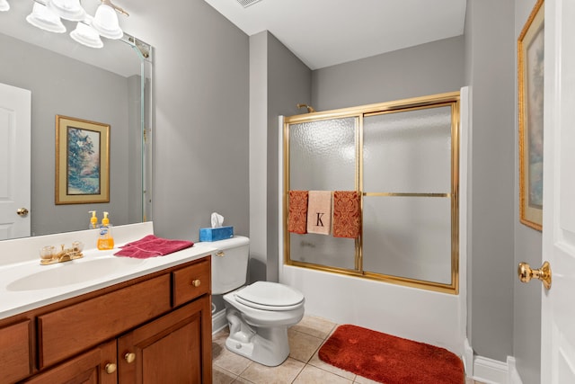 full bathroom with vanity, tile patterned floors, shower / bath combination with glass door, and toilet