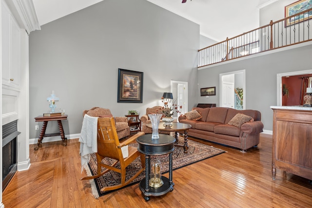 living room with a towering ceiling and light hardwood / wood-style floors