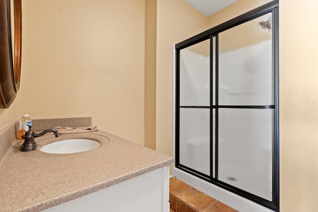 bathroom with walk in shower and vanity