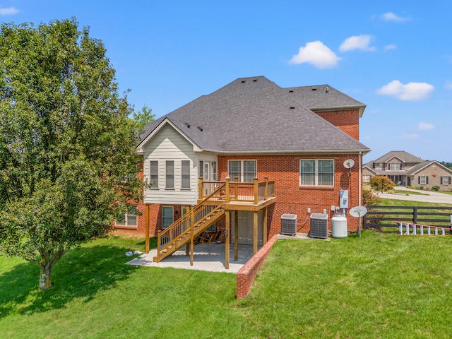 back of property with cooling unit, a deck, a patio area, and a lawn