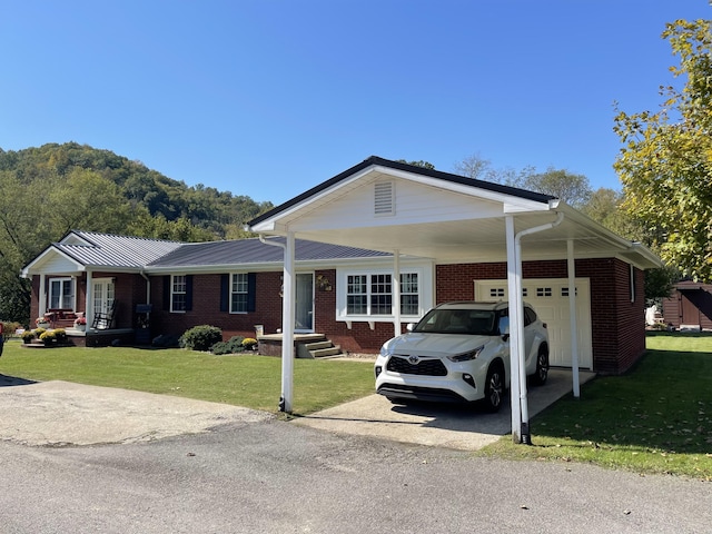 ranch-style home featuring a garage, a front lawn, and a carport