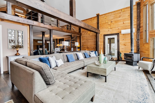489 Sally J Rd, Mount Vernon, KY 40456 - living area with a towering ceiling, a wood stove, wood walls, wood finished floors, and a wall unit AC
