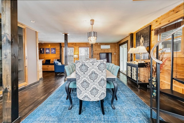 489 Sally J Rd, Mount Vernon, KY 40456 - dining area with wood walls, a wall unit AC, dark wood-style flooring, and a chandelier