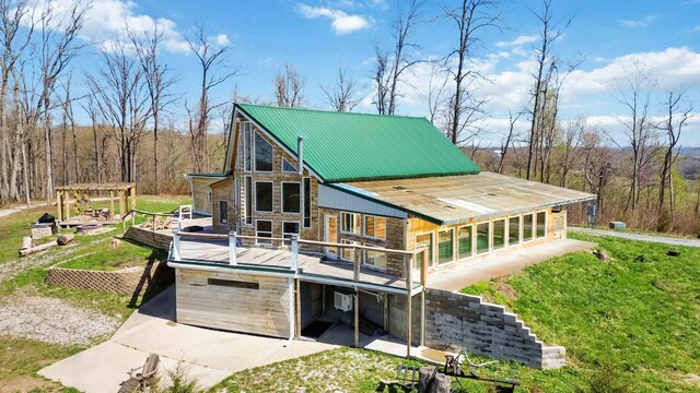 489 Sally J Rd, Mount Vernon, KY 40456 - rear view of property featuring a deck, metal roof, a lawn, and stone siding