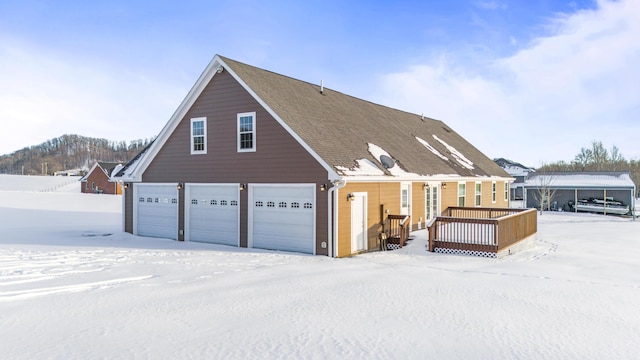 view of snowy exterior featuring a deck