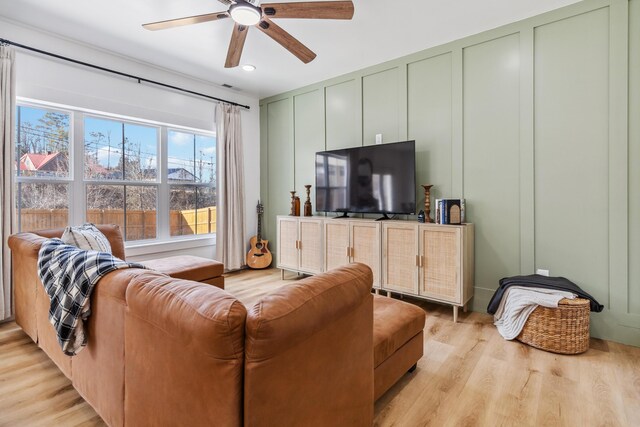 living room featuring ceiling fan and light hardwood / wood-style flooring