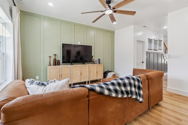 living room with ceiling fan and light wood-type flooring