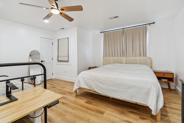 bedroom with ceiling fan and hardwood / wood-style floors