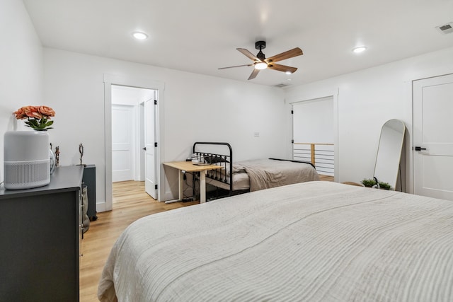 bedroom with light hardwood / wood-style floors and ceiling fan