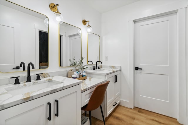 bathroom with vanity and wood-type flooring