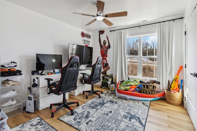 home office with hardwood / wood-style flooring and ceiling fan